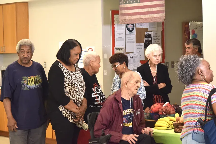 The seniors eagerly await to purchase fresh fruits and vegetables provided by Tonya Cryer of Farmer Daughters Non-profit community outreach & Cryer's Family Produce out of Mt. Hermon, La They are receiving the 50% OFF incentive provided by Market Umbrella's Greaux the Good nutrition program