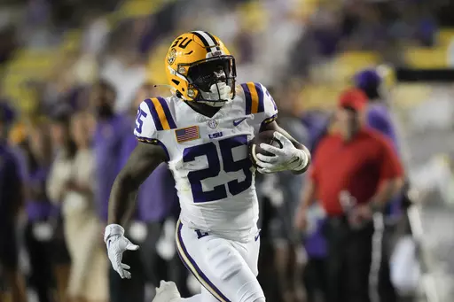 LSU running back Trey Holly (25) carries for a touchdown during the second half of the team's NCAA college football game against Army in Baton Rouge, La., Oct. 21, 2023. The LSU freshman was arrested Thursday, Feb. 15, 2024, and charged with attempted second-degree murder and other charges after a shooting last week that injured two people. (AP Photo/Gerald Herbert, File)