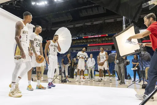 Forward Brandon Ingram, center rear, and guard Trey Murphy III (25) watch as Dejounte Murray, from left, Jordan Hawkins, and CJ McCollum, pose at the New Orleans Pelicans NBA basketball team's media day at the Smoothie King Center in New Orleans, Monday, Sept. 30, 2024.(Chris Granger/The Times-Picayune/The New Orleans Advocate via AP)