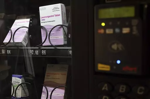 A vending machine is stocked with emergency contraceptives at Odegaard Library on the campus of the University of Washington, Friday, June 2, 2023, in Seattle. After a student-led campaign to install the emergency contraceptive vending machine on campus in November, boxes of generic Plan B have been available to students for $12.60, a fraction of the cost charged in stores. (Kevin Clark/The Seattle Times via AP)