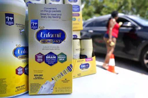 Katherine Gibson-Haynes helps distribute infant formula during a baby formula drive Saturday, May 14, 2022, in Houston. Parents seeking baby formula are running into bare supermarket and pharmacy shelves in part because of ongoing supply disruptions and a recent safety recall. (AP Photo/David J. Phillip)