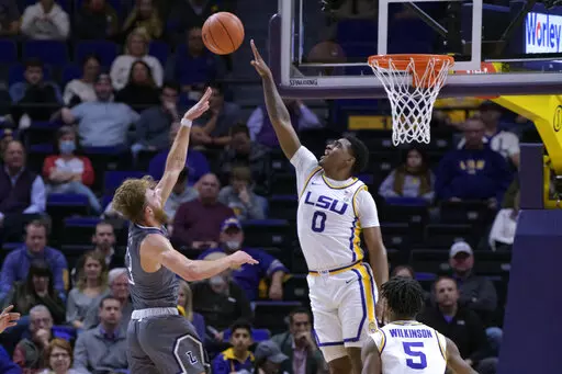 LSU guard Brandon Murray (0) blocks the shot by Lipscomb forward Parker Hazen (13) during the first half of an NCAA college basketball game in Baton Rouge, La., Wednesday, Dec. 22, 2021. (AP Photo/Matthew Hinton)