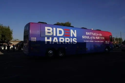Democratic presidential candidate former Vice President Joe Biden and Democratic vice presidential candidate Sen. Kamala Harris, D-Calif., ride on a bus in Phoenix, Oct. 8, 2020, on a small business bus tour. (AP Photo/Carolyn Kaster, File)