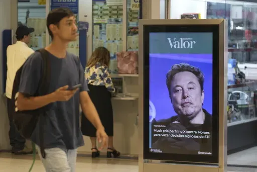 An ad by Valor media shows a photo of Elon Musk at a shopping center in Brasilia, Brazil, Monday, Sept. 2, 2024. The sign reads in Portuguese: "Musk creates profile on X against Moraes to leak confidential decisions of the Supreme Court," referring to Supreme Court Justice Alexandre de Moraes who ordered the platform blocked for having failed to name a local legal representative as required by law. (AP Photo/Eraldo Peres)