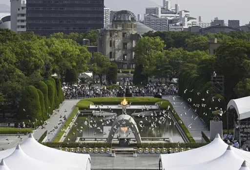 Doves fly over the cenotaph dedicated to the victims of the atomic bombing during an annual ceremony marking the 79th anniversary of the world's first atomic bombing, at the Peace Memorial Park in Hiroshima, western Japan, Tuesday, Aug. 6, 2024. (Yu Nakajima/Kyodo News via AP)