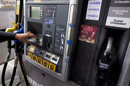 A woman presses button to fill up a gas tank at a gas station in East Dundee, Ill., Saturday, March 19, 2022.  The Conference Board, a business research group, said Tuesday, April 26,  that its consumer confidence index — which takes into account consumers’ assessment of current conditions and their outlook for the future — edged down to 107.3 in April from 107.6 in March. (AP Photo/Nam Y. Huh, File)