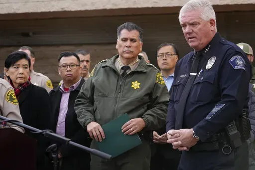 Los Angeles County Sheriff Robert Luna, center, and Monterey Park Chief of Police Scott Wiese, far right, brief the media outside the Civic Center in Monterey Park, Calif., Sunday, Jan. 22, 2023. At left, Rep. Judy Chu, and Monterrey Park Mayor Henry Lo. A mass shooting at a Los Angeles-area ballroom dance club following a Lunar New Year celebration, set off a manhunt for the suspect. (AP Photo/Damian Dovarganes)