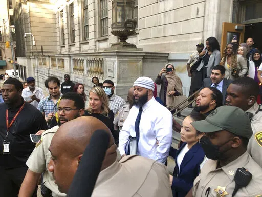 Adnan Syed, center, leaves the Elijah E. Cummings Courthouse, Monday, Sept. 19, 2022, in Baltimore. A judge has ordered the release of Syed after overturning his conviction for a 1999 murder that was chronicled in the hit podcast “Serial.” (AP Photo/Brian Witte)