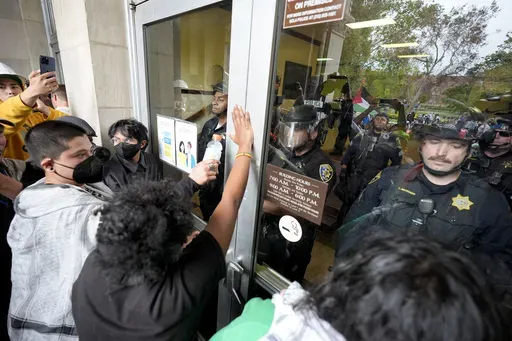 Police block pro-Palestinian demonstrators from entering a building on the UCLA campus, May 23, 2024, in Los Angeles. (AP Photo/Ryan Sun, File)