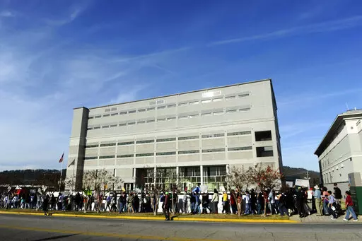 FILE -- Protesters march in front of the Etowah County Detention Center in Gadsden, Ala., Saturday, Dec. 3, 2011. Federal immigration authorities say they will stop housing detainees at the jail citing a history of problems, and they will limit the use of three other detention centers. (Sarah Dudik/The Gadsden Times via AP)
