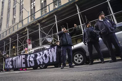 Demonstrators unveil a banner outside Manhattan's district attorney office, supporting a grand jury vote to indict former President Donald Trump, Thursday March 30, 2023, in New York. A Manhattan grand jury has voted to indict Donald Trump on charges involving payments made during the 2016 presidential campaign to silence claims of an extramarital sexual encounter, his lawyers said Thursday, producing the first criminal case against a former U.S. president and a jolt to Trump’s bid to retake t