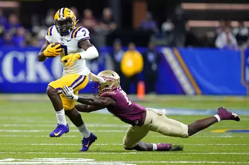 LSU wide receiver Kayshon Boutte (7) carries against Florida State defensive back Omarion Cooper in the second half of an NCAA college football game in New Orleans, Sunday, Sept. 4, 2022. Florida State won 24-23. (AP Photo/Gerald Herbert)