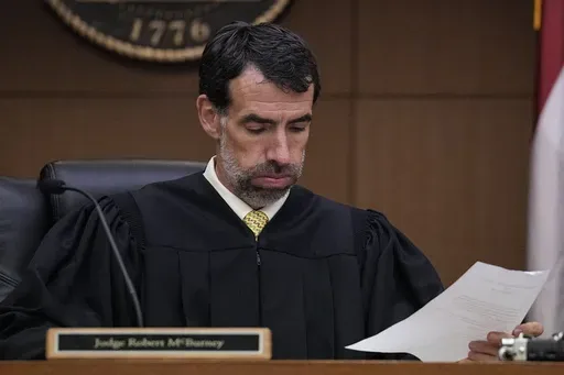 Fulton County Superior Court Judge Robert McBurney looks through paperwork, Monday, Aug. 14, 2023, in Atlanta. (AP Photo/Brynn Anderson, File)