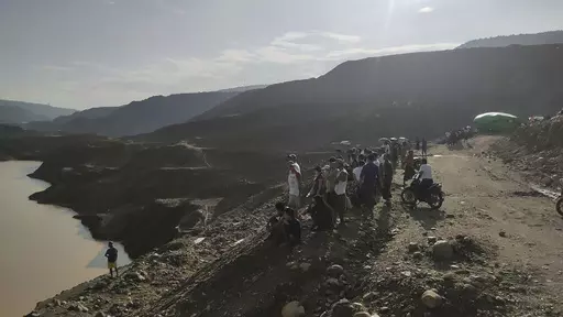 Miners, rescuers and local residents look at the jade mine site where a landslide accident took place in Hpakant township, Kachin state, Myanmar Sunday, Aug. 13, 2023. A landslide at the jade mine left scores of people missing, and a search and rescue operation was underway on Monday, a rescue official said. (AP Photo)