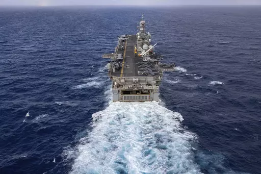 In this handout photo from the U.S. Navy, the Wasp-class amphibious assault ship USS Bataan travels through Atlantic Ocean on July 20, 2023. Thousands of Marines backed by the United States' top fighter jet, warships and other aircraft are slowly building up in the Persian Gulf. It's a sign that while America's wars in the region may be over, its conflict with Iran over its advancing nuclear program only continues to worsen with no solutions in sight. (Mass Communication Specialist 2nd Class Dan