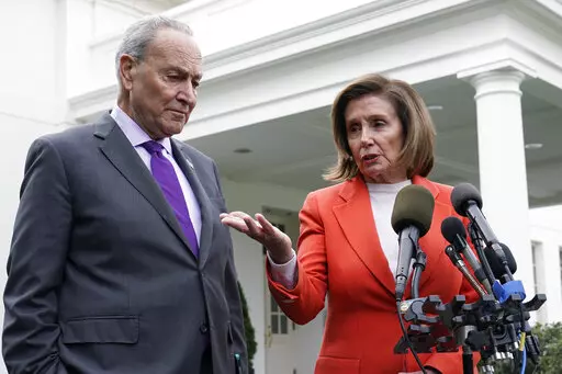 Senate Majority Leader Chuck Schumer of N.Y., right, listens as House Speaker Nancy Pelosi of Calif., left, speaks to reporters at the White House in Washington, Nov. 29, 2022, about their meeting with President Joe Biden. Congress is moving swiftly to prevent a looming U.S. rail workers strike. Lawmakers are reluctantly intervening in a labor dispute to stop what would surely be a devastating blow to the nation’s economy if the transportation of fuel, food and other critical goods was disrupt