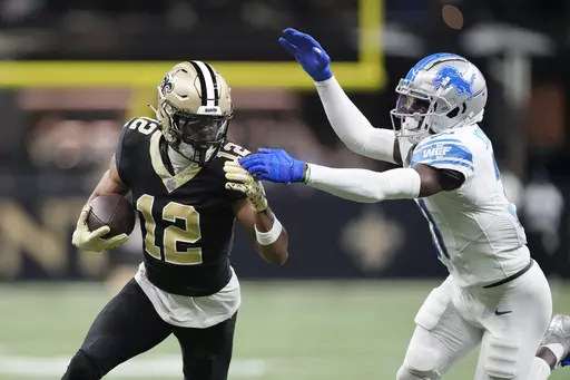 Detroit Lions safety Kerby Joseph closes in on New Orleans Saints wide receiver Chris Olave (12) during the first half of an NFL football game, Sunday, Dec. 3, 2023, in New Orleans. (AP Photo/Gerald Herbert)