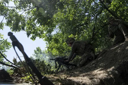 A Ukrainian marine of 35th brigade fires by automatic grenade launcher AGS-17 towards Russian positions on the outskirts of Avdiivka, Ukraine, on June 19, 2023. Ukrainian troops are under intense pressure from a determined Russian effort to storm the strategically important eastern Ukraine city of Avdiivka, officials say. Kyiv’s army is struggling with ammunition shortages as the Kremlin’s forces pursue a battlefield triumph around the two-year anniversary of Moscow’s full-scale invasion a
