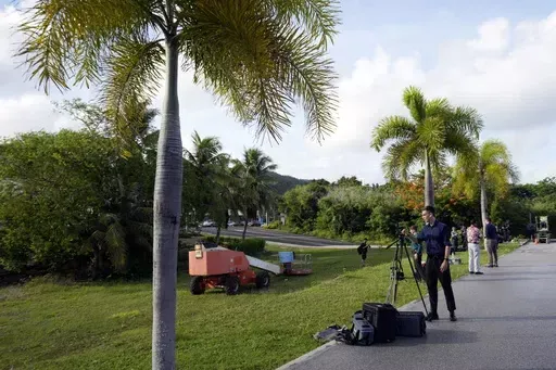 Journalists set up their camera to cover WikiLeaks founder Julian Assange who was brought to court to enter a plea deal, in Saipan, Mariana Islands, Wednesday, June 26, 2024. (AP Photo/Eugene Hoshiko)