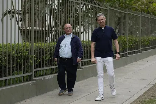 Vatican investigators Monsignor Jordi Bertomeu, right, from Spain, and Archbishop Charles Scicluna, from Malta, walk outside of the Nunciatura Apostolica during a break from meeting with people who alleged abuse by the Catholic lay group Sodalitium Christianae Vitae in Lima, Peru, on July 25, 2023. (AP Photo/Martin Mejia, File)