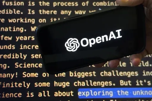 The OpenAI logo appears on a mobile phone in front of a screen showing part of the company website in this photo taken on Nov. 21, 2023 in New York. Negotiators will meet this week to hammer out details of European Union artificial intelligence rules but the process has been bogged down by a simmering last-minute battle over how to govern systems that underpin general purpose AI services like OpenAI's ChatGPT and Google's Bard chatbot. (AP Photo/Peter Morgan, File)