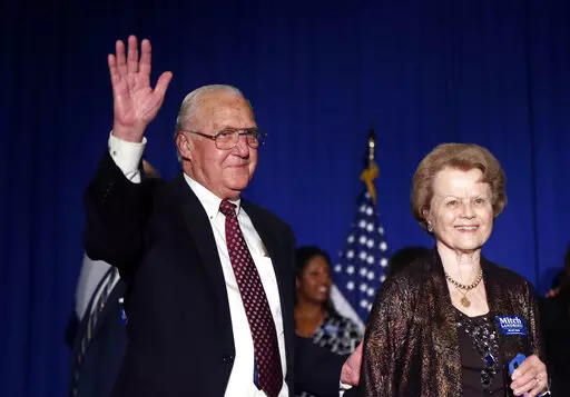 Former New Orleans Mayor Moon Landrieu waves with his wife Verna before his son, incumbent New Orleans Mayor Mitch Landrieu, arrives to address supporters after winning reelection in New Orleans, Saturday, Feb. 1, 2014. Moon Landrieu, the patriarch of a Louisiana political family who was a lonely voice for civil rights until the tide turned in the 1960s, has died at age 92. A family friend said Landrieu died Monday, Sept. 5, 2022. (AP Photo/Gerald Herbert, File)