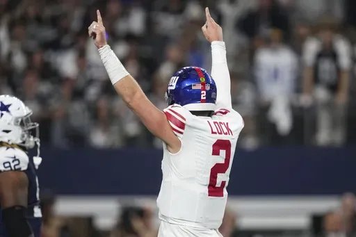 New York Giants quarterback Drew Lock (2) celebrates after running back Tyrone Tracy Jr. (29) scored a touchdown against the Dallas Cowboys during the first half of an NFL football game in Arlington, Texas, Thursday, Nov. 28, 2024. (AP Photo/Tony Gutierrez)