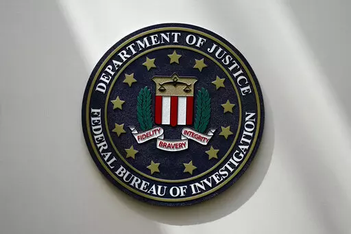 An FBI seal is seen on a wall on Aug. 10, 2022, in Omaha, Neb. The FBI sounded the alarm Monday, Dec. 19, about an explosive increase in teenage boys being targeted online and extorted for money after being tricked into sending sexually explicit pictures. (AP Photo/Charlie Neibergall, File)