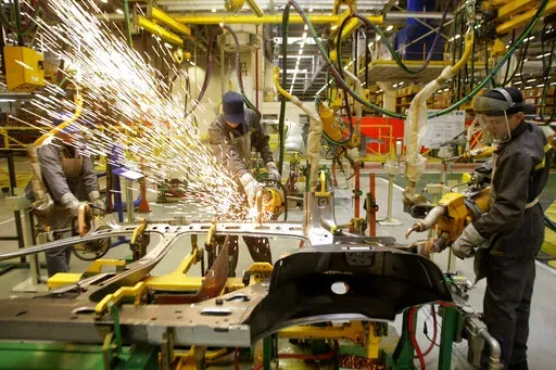 Workers of Renault's Moscow plant prepare car parts for the production line, on March 1, 2010. French automaker Renault moved to pause production at its Moscow plant in an apparent move to fend off mounting criticism, breaking ranks with other major French companies that have defied pressure to keep operating in Russia. The company's board of directors voted Wednesday night to suspend “activities at the Renault Moscow plant." It came hours after Ukrainian President Volodymyr Zelenskyy accused 