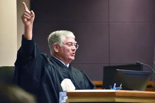 Montana District Judge Michael Moses gestures during a court hearing over a state health department rule that prevents transgender people from changing their birth certificates, Thursday, Sept. 15, 2022, in Billings, Mont. Moses struck down the rule at the conclusion of the hearing. (AP Photos/Matthew Brown)