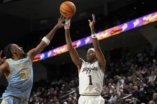 Southern University guard Tidjiane Dioumassi (22) defends a three point shot against Texas A&M guard Zhuric Phelps (1) during the first half of an NCAA college basketball game Wednesday, Nov. 20, 2024, in College Station, Texas. (AP Photo/Sam Craft)