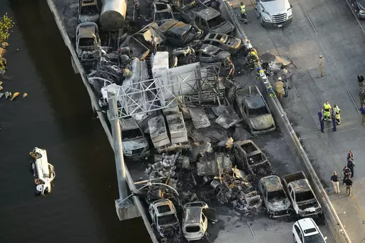 In this aerial photo, responders are seen near wreckage in the aftermath of a multi-vehicle pileup on Interstate 55 in Manchac, La., Monday, Oct. 23, 2023. The death toll from last week’s series of highway crashes blamed on a “super fog” of smoke from marsh fires and morning fog has been lowered from eight to seven, Louisiana State Police said Friday, Oct. 27. (AP Photo/Gerald Herbert, File)