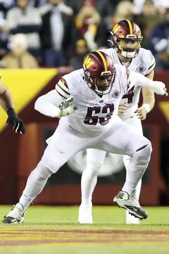 Washington Commanders guard Trai Turner (53) blocks during an NFL football game against the Dallas Cowboys, Sunday, Jan. 8, 2023 in Landover. The New Orleans Saints have brought back former tight end Jimmy Graham and also agreed to contract terms with guard Trai Turner. The moves came Tuesday, July 25, 2023, as veterans reported for the club's training camp at team headquarters. (AP Photo/Daniel Kucin Jr.)