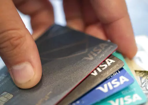 This Aug. 11, 2019 file photo shows Visa credit cards in New Orleans. Even if your credit card already earns solid ongoing rewards, there are several ways to rev up those earnings, especially amid the heavy shopping that tends to happen during the holiday season. First, look for lucrative sign-up bonuses when you open a credit card and meet a spending threshold. Beyond that, other opportunities abound — from online shopping portals you can visit to one-time offers you can add to your card as w