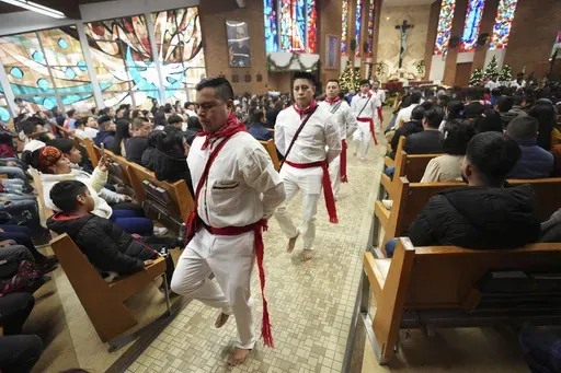 Lucas Lopez leads a traditional Guatemalan dance during Mass celebrating the feast day of the Black Christ of Esquipulas at St. Mary's Catholic Church in Worthington, Minnesota, Sunday, Jan. 12, 2025. (AP Photo/Abbie Parr)