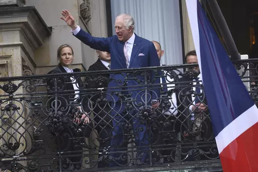 Britain's King Charles III waves from a balcony of the city hall in Hamburg, Germany, Friday, March 31, 2023. King Charles III won plenty of hearts during his three-day visit to Germany, his first foreign trip since becoming king following the death of his mother, Elizabeth II, last year. (AP Photo/Gregor Fischer, File)