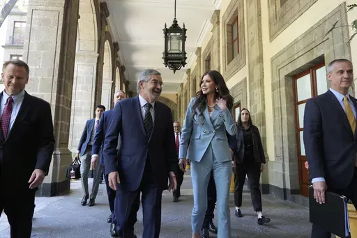 U.S. Homeland Security Secretary Kristi Noem, right, walks with Mexican Foreign Minister Juan Ramon de la Fuente at the National Palace in Mexico City, Friday, March 28, 2025. (AP Photo/Alex Brandon)