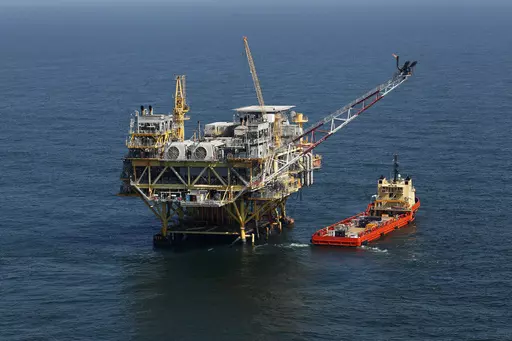 A rig and supply vessel are viewed in the Gulf of Mexico off the cost of Louisiana, April 10, 2011. A sale of federal Gulf of Mexico oil and gas leases that had been scheduled for Wednesday, Nov. 8, 2023, was delayed Thursday, Oct. 26, 2023, by a federal appeals court, pending court arguments that focus on protections for an endangered whale species. (AP Photo/Gerald Herbert, File)