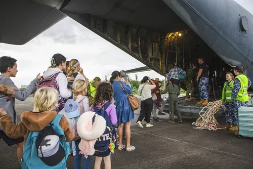 In this photo provided by the Australian Department of Defence, Australian and other tourists board an Australian Airforce Hercules as they prepare to depart from Magenta Airport in Noumea, New Caledonia, Tuesday, May 21, 2024. Australia and New Zealand have sent airplanes to New Caledonia to begin bringing home stranded citizens from the violence-wracked French South Pacific territory. (LAC Adam Abela/Royal Australian Airfare via AP)