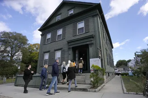 Visitors enter the Lizzie Borden House, site of an 1892 double axe murder, Wednesday, Oct. 16, 2024, in Fall River, Mass. (AP Photo/Steven Senne)
