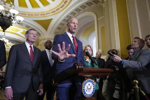 Senate Majority Leader John Thune, R-S.D., joined by Sen. John Barrasso, R-Wyo., the GOP whip, left, talks to reporters at the Capitol, in Washington, Tuesday, April 1, 2025. (AP Photo/J. Scott Applewhite)