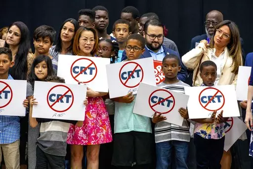 Kids holding signs against Critical Race Theory stand on stage near Florida Gov. Ron DeSantis as he addresses the crowd before publicly signing HB7 at Mater Academy Charter Middle/High School in Hialeah Gardens, Fla., on April 22, 2022. Republican groups that sought to get hundreds of “parents’ rights” activists elected to local school boards largely fell short in Tuesday’s elections. The push has been boosted by Republican groups including the 1776 Project PAC, but just a third of its r