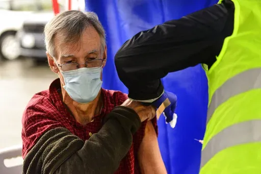 Crager Boardman, from Brattleboro, Vt., receives a shot at a flu vaccine clinic in Brattleboro on Tuesday, Oct. 26, 2021. On Wednesday, June 22, 2022, a federal advisory panel says Americans 65 and older should get newer, souped-up flu vaccines. The panel unanimously recommended certain flu vaccines for seniors, whose weakened immune systems don’t respond as well to traditional shots. (Kristopher Radder/The Brattleboro Reformer via AP, File)