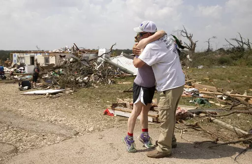 Michelle Light hugs her uncle Paul Bales on Wednesday April 13, 2022, a day after a tornado destroyed her home on FM 2843 and Cedar Valley Road near Salado, Texas. Nearly two dozen people were injured when tornadoes swept through central Texas as part of a storm system that’s expected to spawn more twisters and damaging winds Wednesday (Jay Janner/Austin American-Statesman via AP)