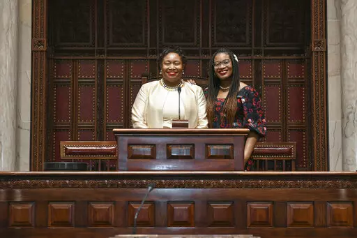 Judge Shirley Troutman stands with her daughter, Lauren Howard, in the New York Senate Chamber in Albany, N.Y., Jan. 12, 2022.  Troutman is among 17 Black women and 14 Black men currently serving on their state's highest court, according to the Brennan Center for Justice in New York, which has tracked diversity on those courts. (N.Y. State Senate via AP, File)