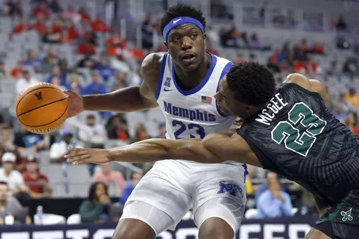 Memphis forward Malcolm Dandridge (23) goes to the basket as Tulane guard R.J. McGee (23) reaches in during first half of an NCAA college basketball game in the semifinals of the American Athletic Conference Tournament, Saturday, March 11, 2023, in Fort Worth, Texas. (AP Photo/Ron Jenkins)