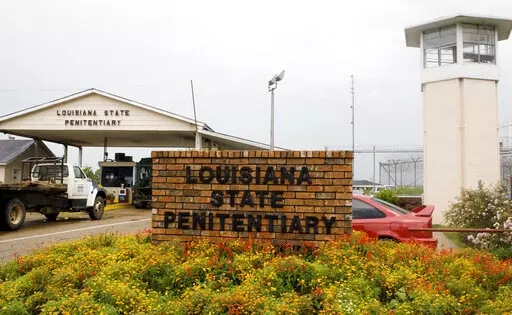 Vehicles enter at the main security gate at the Louisiana State Penitentiary — the Angola Prison, the largest high-security prison in the country in Angola, La., Aug. 5, 2008. A controversial transfer of juvenile prisoners to a temporary facility at Louisiana’s sprawling high security prison farm for adult convicts involves a shuffle of youths to and from four different lockups around the state, officials said Thursday, Oct. 20, 2022. (AP Photo/Judi Bottoni, File)