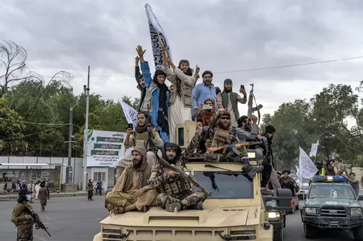 Taliban fighters celebrate one year since they seized the Afghan capital, Kabul, in front of the U.S. Embassy in Kabul, Afghanistan, Monday, Aug. 15, 2022. (AP Photo/Ebrahim Noroozi, File)