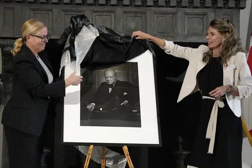 Canadian Cultural Heritage Deputy Minister, Isabelle Mondou, left, and Andrea Clark-Grignon, Head of Public Affairs, unveil a photographic portrait known as 'The Roaring Lion', taken by photographer Yousuf Karsh in 1941 of Britain's Prime Minister Winston Churchill, stolen in Canada in 2022, and returned during a ceremony at the Canada's embassy in Rome, Thursday, Sept. 19, 2024. (AP Photo/Alessandra Tarantino)