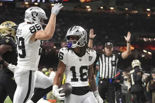 Las Vegas Raiders wide receiver Jakobi Meyers (16) celebrates with teammate tight end Brock Bowers (89) after catching a 3-yard touchdown pass during the first half of an NFL football game against the New Orleans Saints, Friday, Nov. 29, 2024, in New Orleans. (AP Photo/Gerald Herbert)